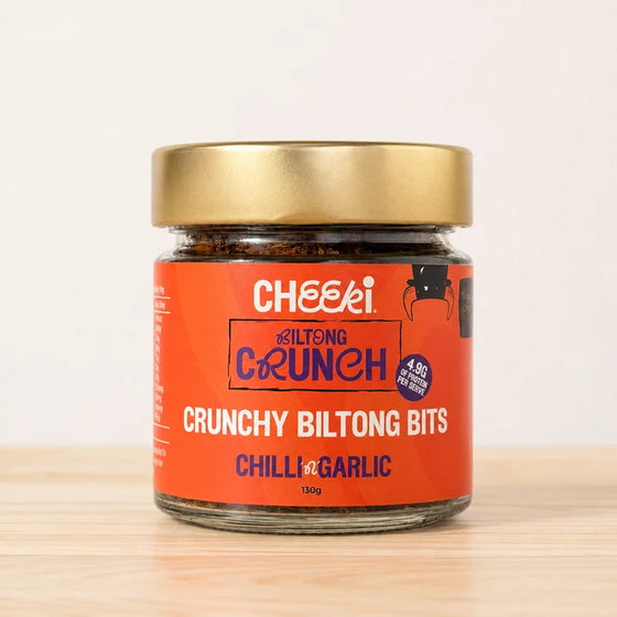 A glass jar of Cheeki Chilli Crunch Crunchy Biltong Bits premium Australian organic grass-fed beef biltong and transforms it into crunchy biltong bits unlocking versatility to step up flavour and protein with any meal.